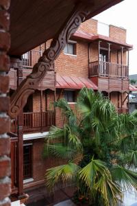 a brick building with palm trees in front of it at Hotel Thamel House in Kathmandu