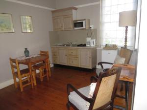 a kitchen with a table and a kitchen with a dining room at Le Manse in Franschhoek