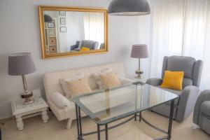 a living room with a couch and a glass table at Santa Cecilia in Córdoba