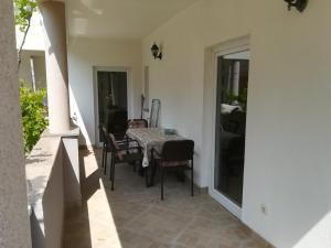 a dining room with a table and chairs on a patio at Apartments Vito in Nin