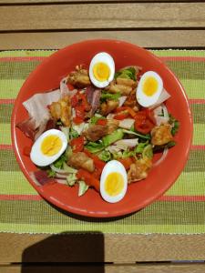 a plate of food with eggs on a table at Casa los tejones in Pinos del Valle