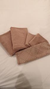 a brown towel sitting on top of a bed at Hills Hotel Gotanda in Tokyo