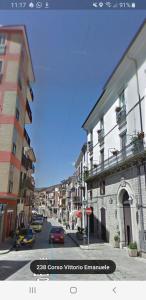 a city street with buildings and a car on the road at Appartamento storico in pieno centro ad Agnone in Agnone