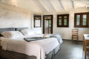 a bedroom with a large bed with a hat on it at Enetiko Resort in Parga