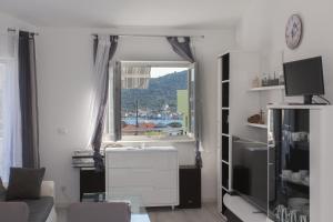 a living room with a window and a couch at Villa Supuk in Vinišće