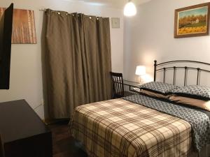 a small bedroom with a bed and a window at Nisku Guest House in Nisku