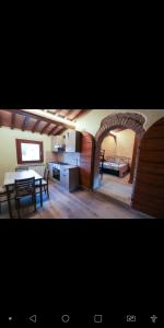 a kitchen and a living room with a table and a dining room at Agriturismo la Tana in Città di Castello