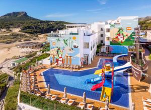 a resort with a pool and a roller coaster at VIVA Cala Mesquida Resort & Spa in Cala Mesquida