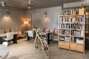 a room with a book shelf and a bike at Enetiko Resort in Parga