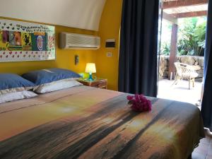 a bedroom with a large bed with a flower on it at Residenza delle Palme in Pantelleria