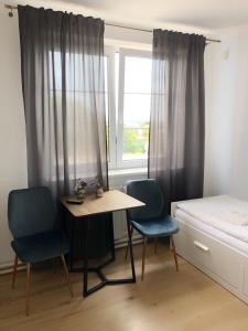 1 dormitorio con mesa, 2 sillas y 1 cama en Hotel Gregor, en Modřice