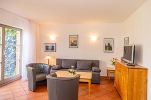 a living room with a couch and a tv at Ferienwohnung Traumurlaub in Dewichow