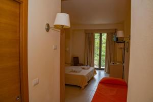 Postel nebo postele na pokoji v ubytování Hotel Milomax