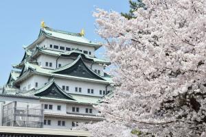 a castle withakura trees in front of a building at Hotel Nature Nagoya Sakae Kishu Railway Group in Nagoya