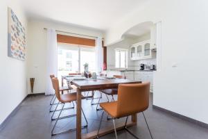 a kitchen with a dining room table and chairs at Sitio da Ponte Family Apartment in Lagos
