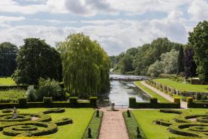 a view of a garden with a river and trees at Coombe Abbey Hotel in Coventry