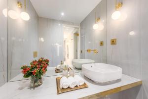 a white bathroom with a sink and a mirror at Victoria Project - Houses - Private Parking in Porto