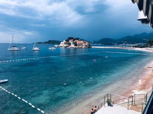 a view of a beach with boats in the water at Apartments Lungo Mare in Sveti Stefan