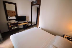 Postel nebo postele na pokoji v ubytování Hotel Lux Fatima