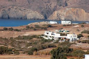 a house on a hill next to a body of water at Galini in Agia Irini Milos