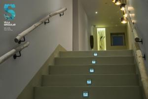 a staircase in a building with a stair railing at Villa Singular in San José