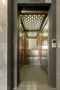 an elevator corridor in a building with a mirror at Oceania Bay Village in Pyla
