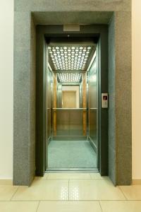 an elevatorexit in a building with a glass door at Oceania Bay Village in Pyla