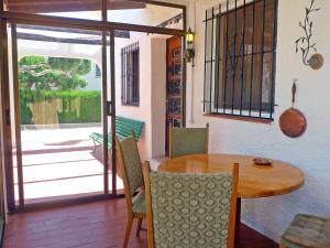 a dining room with a wooden table and chairs at Holiday Home Marinada by Interhome in L'Ampolla