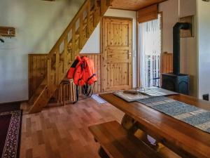 a room with a wooden staircase and a wooden table at Holiday Home Rantasipi 1 by Interhome in Strandby