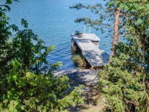 a house in the middle of a body of water at Holiday Home Rantasipi 1 by Interhome in Strandby
