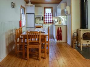 a kitchen and dining room with a table and chairs at Holiday Home Merimetso 6 by Interhome in Strandby +10 photos