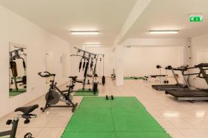 a gym with several treadmills and exercise bikes at Oceania Bay Village in Pyla