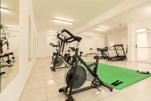 a gym with cardio equipment in a room at Oceania Bay Village in Pyla