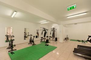 a gym with treadmills and exercise equipment in a room at Oceania Bay Village in Pyla