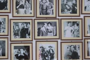 a wall full of pictures of people at Galini in Agia Irini Milos