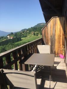 a table and chairs on a deck with a view at Charmant T3 Bussang, Vosges, vue imprenable in Bussang