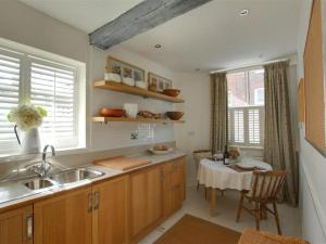 a kitchen with a sink and a table in it at Holiday Home Strand Street by Interhome in Sandwich