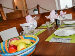 a bowl of fruit sitting on a wooden table at Apartment Casa Eduardo Apt-2 by Interhome in Ronco sopra Ascona +15 photos