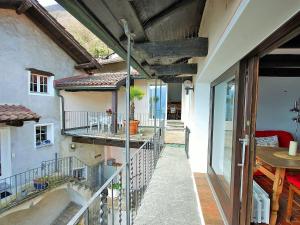 a balcony of a house with a view of the courtyard at Apartment Casa Eduardo Apt-2 by Interhome in Ronco sopra Ascona