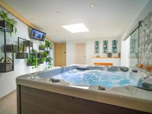 a large bathroom with a large tub with blue water at Villa Minimal by Interhome in Kastav