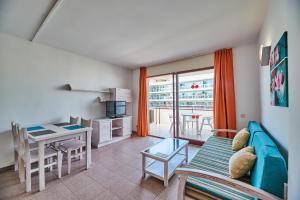 Inter Apartments في سالو: غرفة معيشة مع أريكة وطاولة