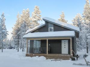 a small cabin in the snow with trees at Holiday Home Pallaskieppi by Interhome in Kyrö
