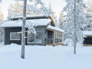 a cabin in the snow with snow covered trees at Holiday Home Pallaskieppi by Interhome in Kyrö