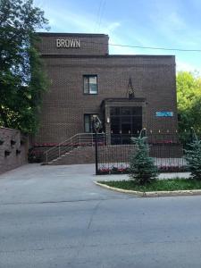 a brick building with a brown sign on it at Brown Hotel in Astana