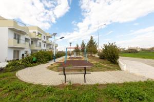 an empty playground in front of a building at Oceania Bay Village in Pyla