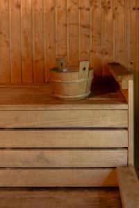 a sauna with a wooden tub sitting on the stairs at Oceania Bay Village in Pyla