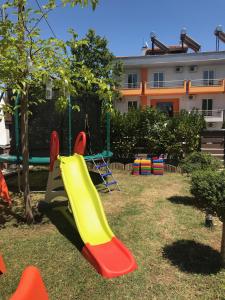 a playground with a slide in a park at Principal New Leisure Hotel in Paralia Katerinis