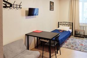 a small room with a table and a bed at DoBeDo Hostel in Yekaterinburg