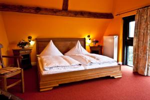 a bedroom with a bed with white pillows on it at Egestorfer Hof in Egestorf