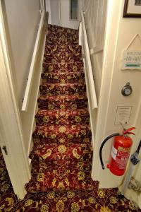 a stairwell with a fire extinguisher on the floor and a fire hydrant at Wortley Cottage Guest House in Wortley